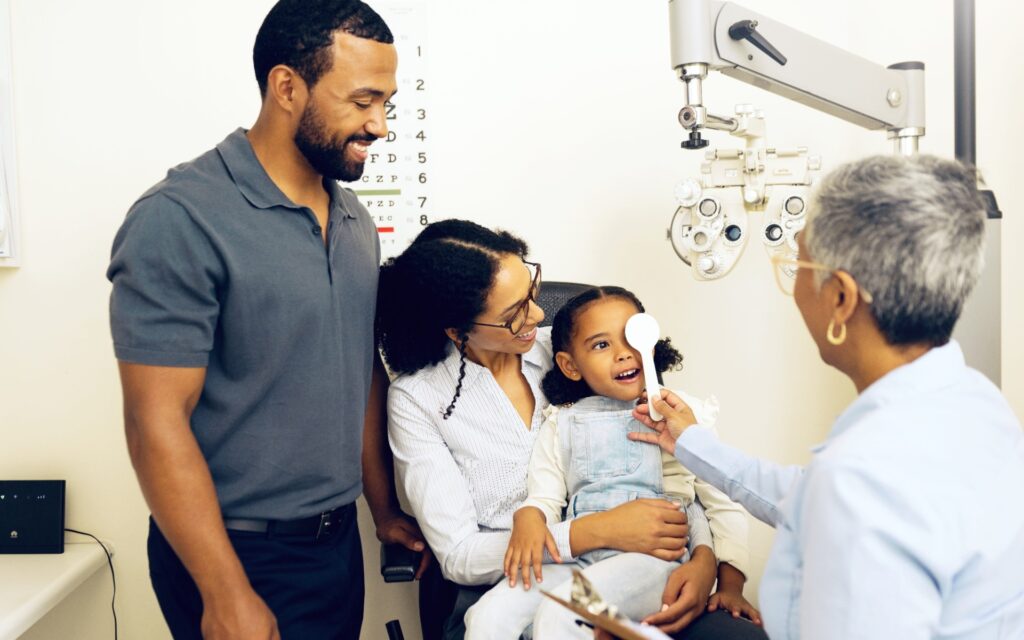 Optometrist checking for amblyopia during children’s eye exam